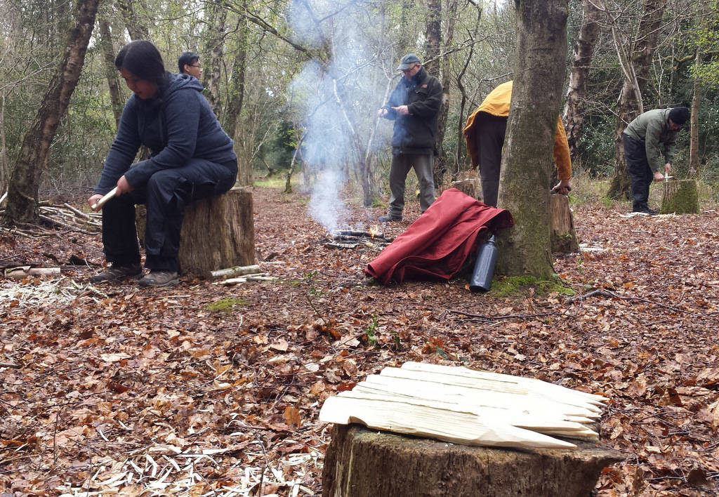 two people setting up a campsite in the woods