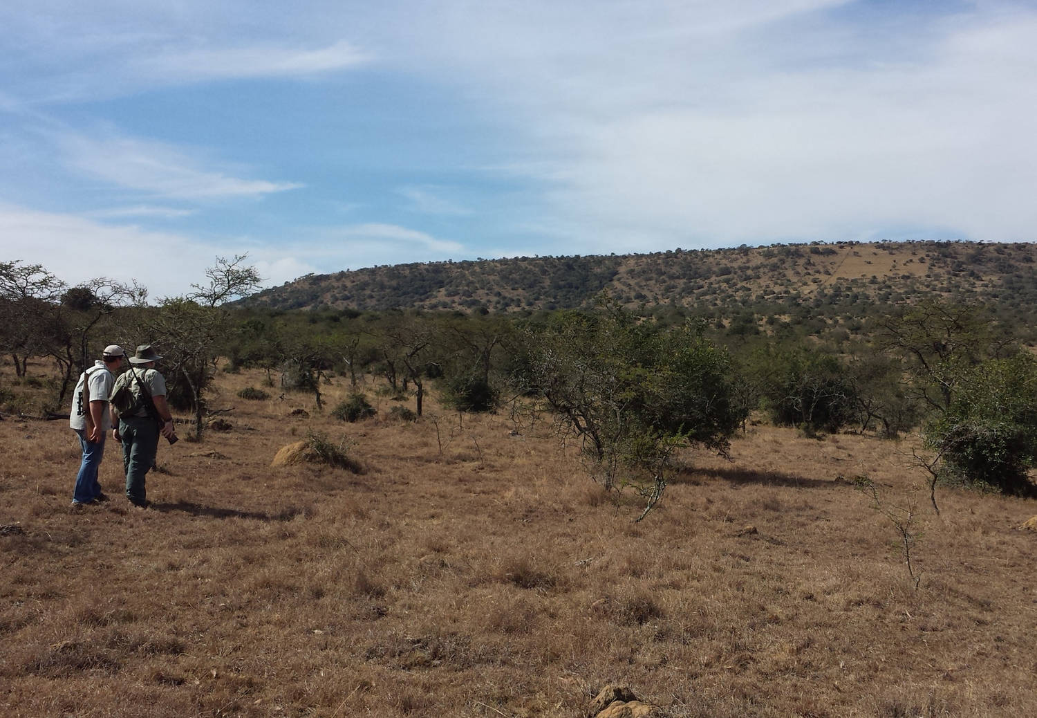 A photograph of two people walking in South Africa