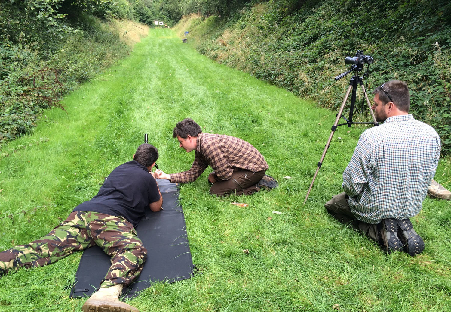 A photograph of three men hunting outdoors